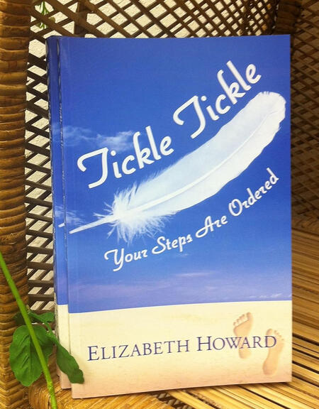 Elizabeth Howard, Christian author, holding two books from her Tickle Tickle children's series that share scripture and faith-filled stories.